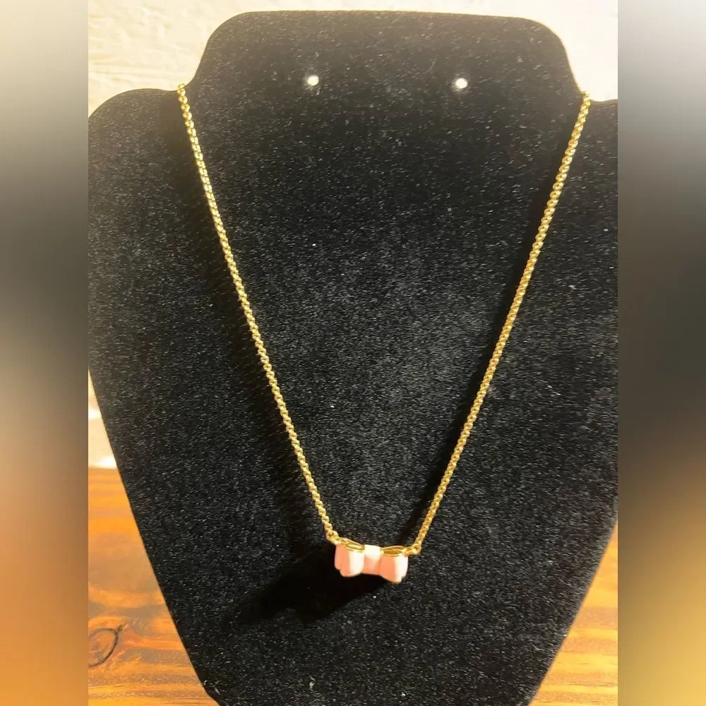 Kate Spade Pink and Gold Bow Necklace gold tone with pink enamel bow feminine